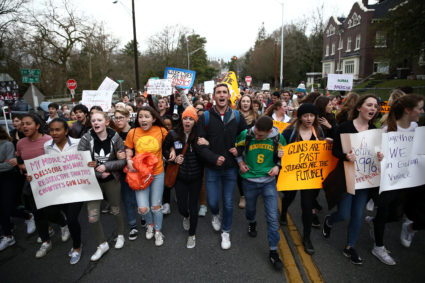 Roosevelt High School student organizers Scout Smissen, 17, and Gabe Rosenbloom march with Zach Heffron, 18, of Nathan Hale High School as they march with hundreds of other students to the University of Washington in the National School Walkout to protest gun violence in Seattle, Washington, U.S, March 14, 2018. REUTERS/LINDSEY WASSON - RC1B6DE90630