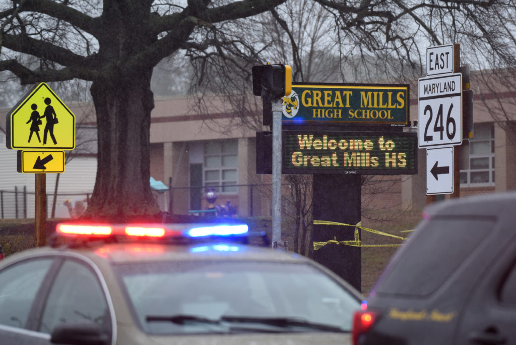 Law enforcement vehicles are seen outside the Great Mills High School following a March 20 shooting in St. Mary's County, ...