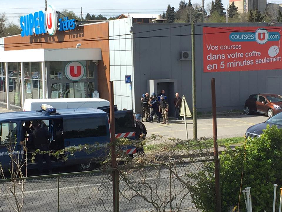 Police are seen at the scene of a hostage situation in a supermarket in Trebes, France, in this picture obtained from a so...