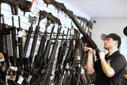 Salesman Ryan Martinez clears the chamber of an AR-15 at the "Ready Gunner" gun store In Provo, Utah, U.S. in Provo, Utah, U.S., June 21, 2016. Photo by George Frey/Reuters