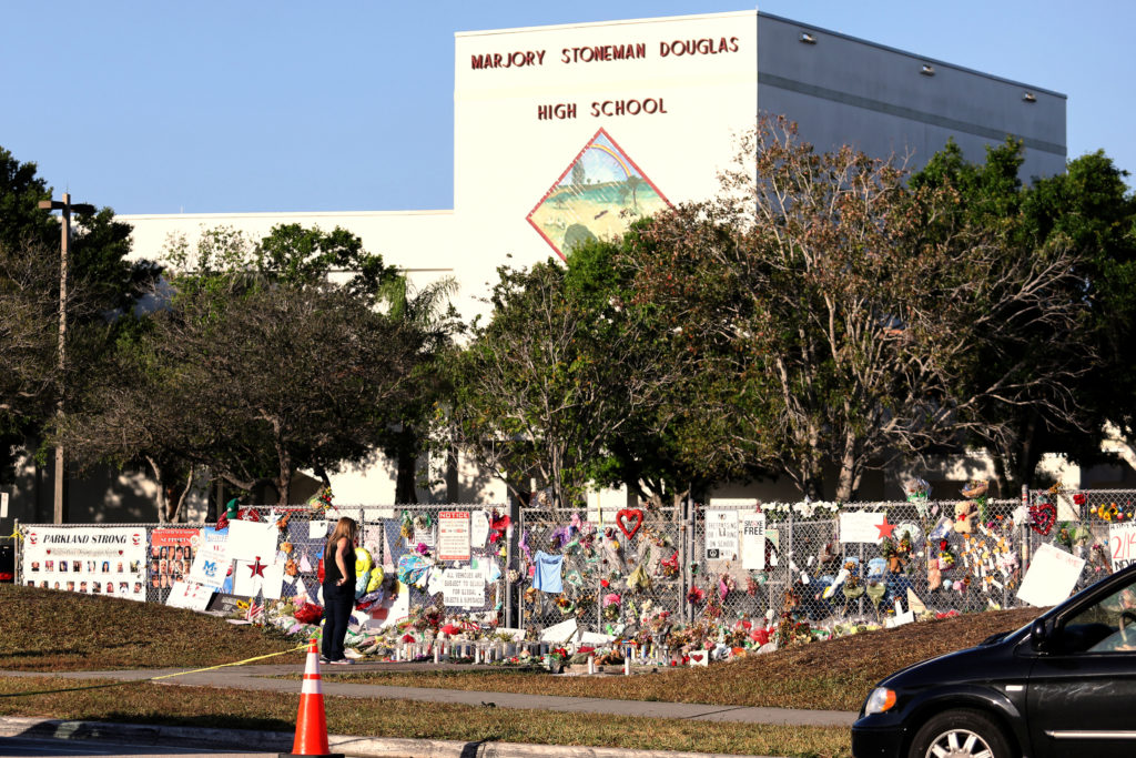 A memorial seen outside of Marjory Stoneman Douglas High School as students arrive for the first time since the mass shoot...