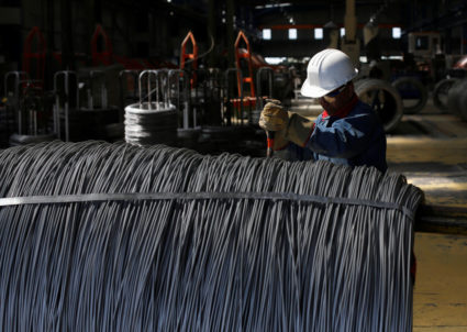 FILE PHOTO: Worker inspects wire rod at TIM stainless steel wire factory in Huamantla