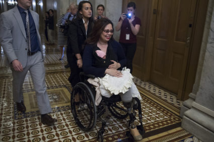 Sen. Tammy Duckworth, D-Ill., brings her baby, Maile Pearl, into the Capitol for a vote. Earlier in the week, a resolution was passed to allow children younger than one-year-old onto the Senate floor for votes. Photo By Tom Williams/CQ Roll Call