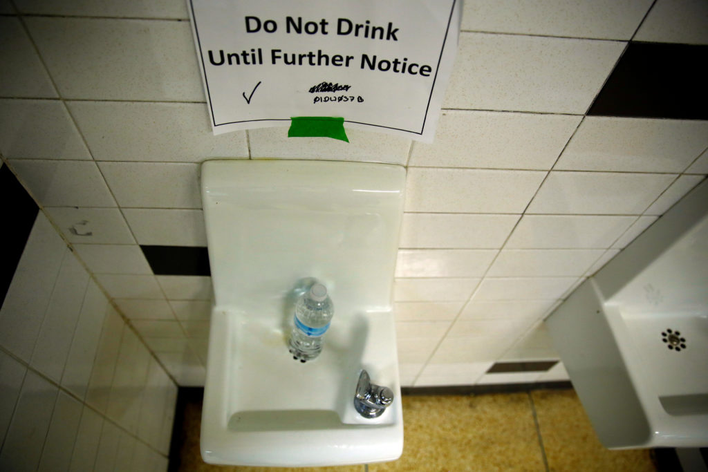 FILE PHOTO: A sign which reads 'Do Not Drink Until Further Notice' appears next to a water dispenser at North Western high...