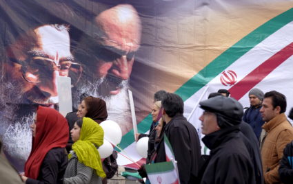 People walk past images of the late leader of the Islamic Revolution Ayatollah Ruhollah Khomeini (right) and Iran's Supreme Leader Ayatollah Ali Khamenei, during a ceremony marking the 37th anniversary of the Islamic Revolution, in Tehran on Feb. 11, 2016. File photo by Raheb Homavandi/TIMA via Reuters