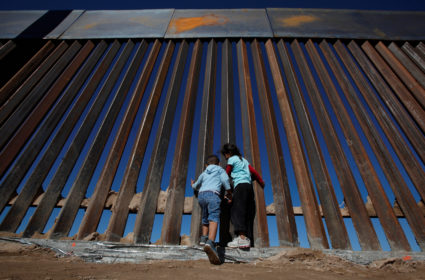 Children play at a newly built section of the U.S.-Mexico border wall. Photo by REUTERS/Jose Luis Gonzalez