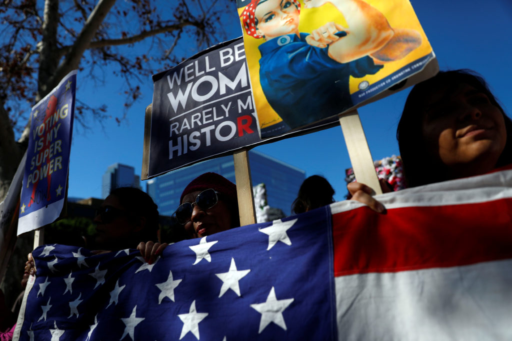 People hold an American flag during the second annual Women's March in Los Angeles, California, U.S. January 20, 2018. REU...