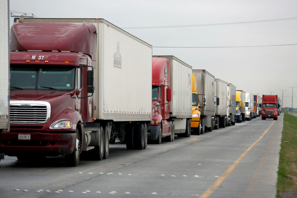 Trucks wait in the queue for border customs control to cross into U.S. at the World Trade Bridge in Nuevo Laredo, Mexico A...