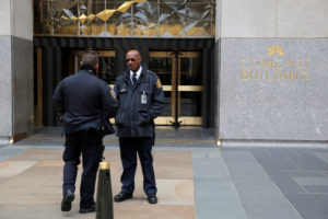 Police and security stand outside 30 Rockefeller Plaza, the location for the offices of U.S. President Donald Tump's lawyer Michael Cohen which was raided by the F.B.I. today in the Manhattan borough of New York City, New York, U.S., April 9, 2018. REUTERS/Andrew Kelly - RC15CC49E700