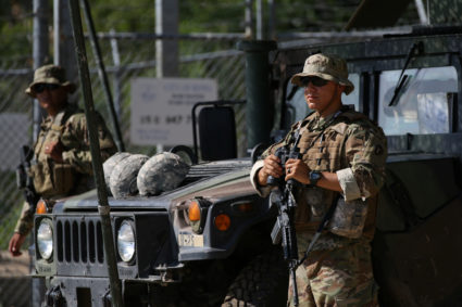 Members of the Texas National Guard watch the Mexico-U.S. border from an outpost along the Rio Grande in Roma, Texas, U.S., April 11, 2018. REUTERS/Loren Elliott - RC1C60511AC0