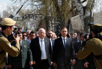 Polish President Andrzej Duda and Israeli President Reuven Rivlin are seen in front of the "Arbeit macht frei" (Work sets you free) gate as they take part in the annual "March of the Living" to commemorate the Holocaust at the former Nazi death camp Auschwitz, in Oswiecim, Poland, April 12, 2018. REUTERS/Kacper Pempel - RC1EB00DCD80