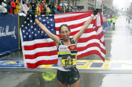 Desiree Linden of the USA holds up the American flag after winning the Women's Division of the 2018 Boston Marathon. Photo by Winslow Townson/USA TODAY Sports