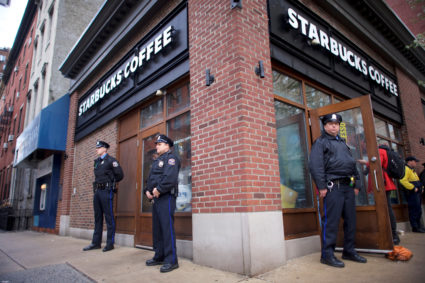 Police officers monitor activity outside as protesters demonstrate inside a Center City Starbucks, where two black men were arrested, in Philadelphia, Pennsylvania. Photo by Mark Makela/Reuters