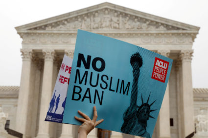Protesters rally outside the Supreme Court, while the court justices consider case regarding presidential powers as it weighs the legality of President Donald Trump's latest travel ban targeting people from Muslim-majority countries, in Washington, D.C. Photo by Yuri Gripas/Reuters