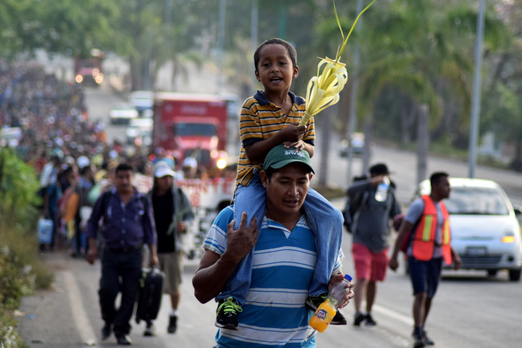 Hundreds of Central Americans attend a mass before they begin a Via Crucis on Palm Sunday from the southern state of Mexic...