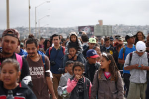 Members of a caravan of migrants from Central America walk towards the United States border and customs facility, where they are expected to apply for asylum, in Tijuana, Mexico April 29, 2018. Photo by REUTERS/Edgard Garrido