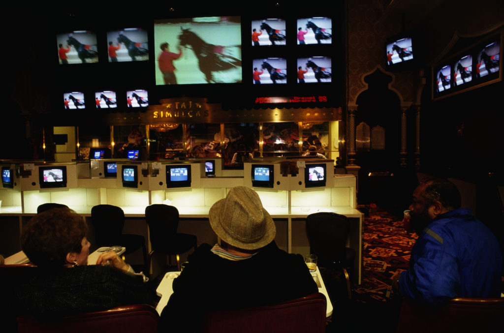 Gamblers watching horse racing. Photo by Mark Peterson/Corbis via Getty Images