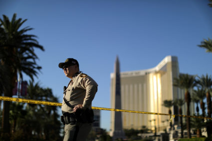 A police officer stands in front of the closed Las Vegas Strip next to the site of the Route 91 music festival mass shooting outside the Mandalay Bay Resort and Casino in Las Vegas, Nevada, U.S., October 3, 2017. REUTERS/Lucy Nicholson - RC136F2FEA50