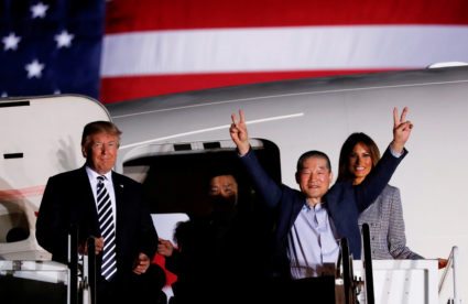 One of the Americans formerly held hostage in North Korea gestures next to President Donald Trump and first lady Melania Trump, upon their arrival at Joint Base Andrews, Maryland. Photo by Jonathan Ernst/Reuters