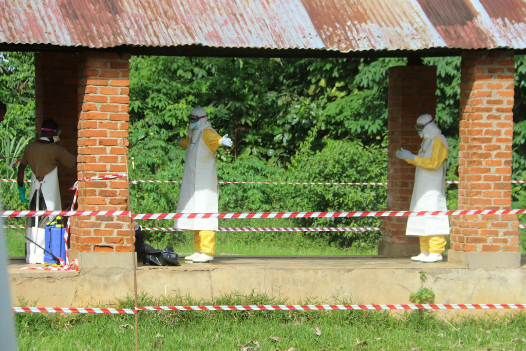 A health worker is sprayed with chlorine after visiting the isolation ward at Bikoro hospital, which received a new suspec...