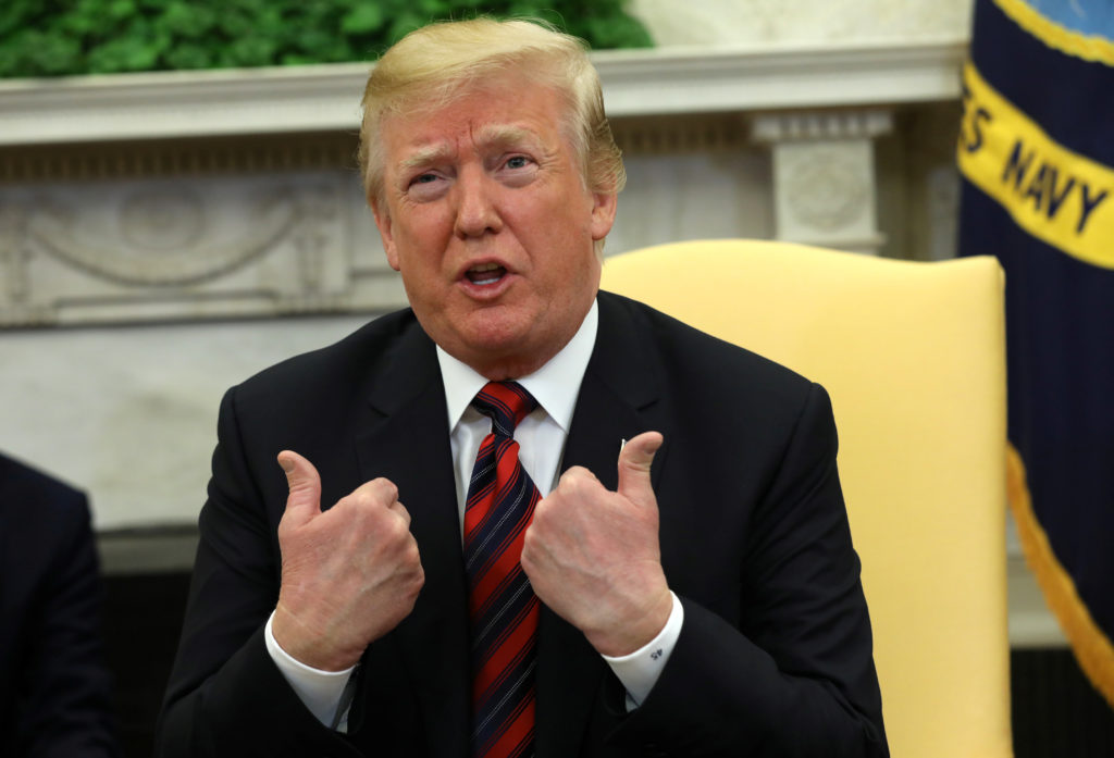 President Donald Trump gestures as he welcomes South Korea's President Moon Jae-In in the Oval Office of the White House i...