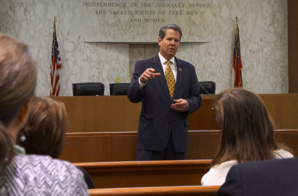 Georgia Secretary of State Brian Kemp speaks with visitors to the state capitol about the "SEC primary" involving a group ...