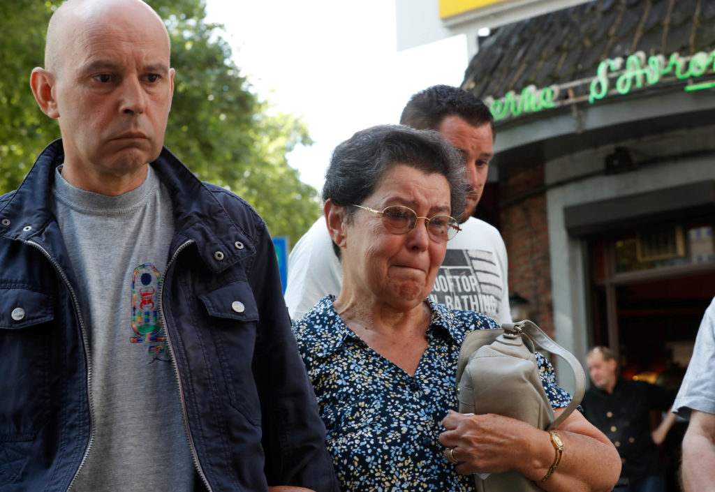 Bernadette Hennart, mother of late police officer Soraya Belkacemi, accompanied by her son Kamel Belkacemi (L), pays tribute to her daughter who was killed on May 29 during a shooting in Liege, Belgium. Photo by Yves Herman/Reuters