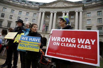 A group of protesters rally against the announcement to reduce automobile emission standards by Administrator of the Environmental Protection Agency (EPA) Scott Pruitt in front of the EPA building in Washington, U.S., April 3, 2018. REUTERS/Joshua Roberts