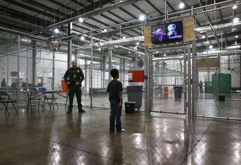 A boy from Honduras watches a movie at a detention facility run by the U.S. Border Patrol on Sept. 8, 2014 in McAllen, Texas. Photo by John Moore/Getty Images