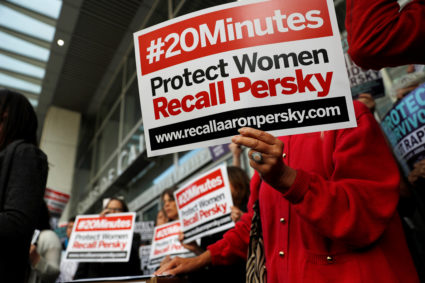 Activists hold signs calling for the removal of Judge Aaron Persky from the bench after his controversial sentencing in the Stanford rape case, in San Francisco, California. Photo taken in 2016. Photo by Stephen Lam/Reuters