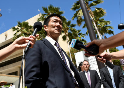 Hawaii Attorney General Douglas Chin talks to the media at the U.S. District Court Ninth Circuit after seeking an extension after filing an amended lawsuit against President Donald Trump's new travel ban in Honolulu, Hawaii, March 29, 2017. REUTERS/Hugh Gentry - RC13B4C11580