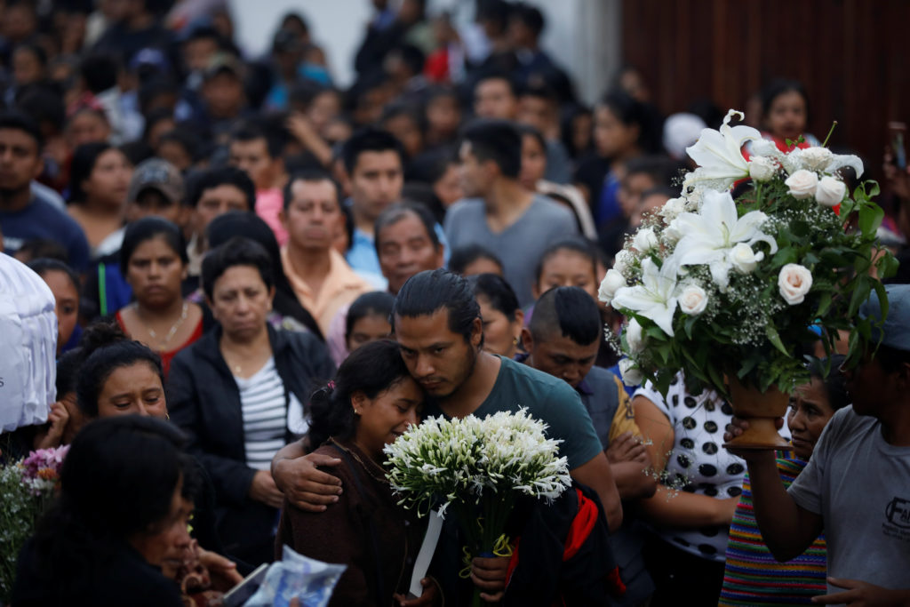 Mourners take part in the funeral of seven victims who died during the eruption of the Fuego volcano in Alotenango, Guatemala. Photo by Jose Cabezas/Reuters