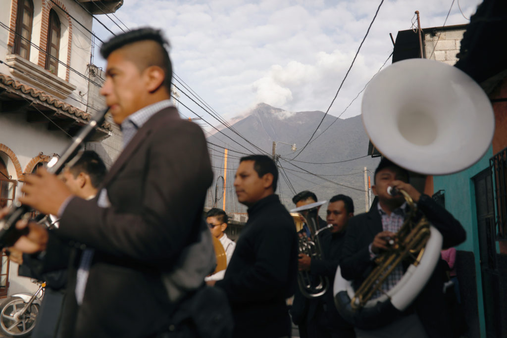 People play music during the funeral of Sergio Vasquez, who died during the eruption of the Fuego volcano in Alotenango, Guatemala June 5, 2018. REUTERS/Jose Cabezas - RC16CE4FA420