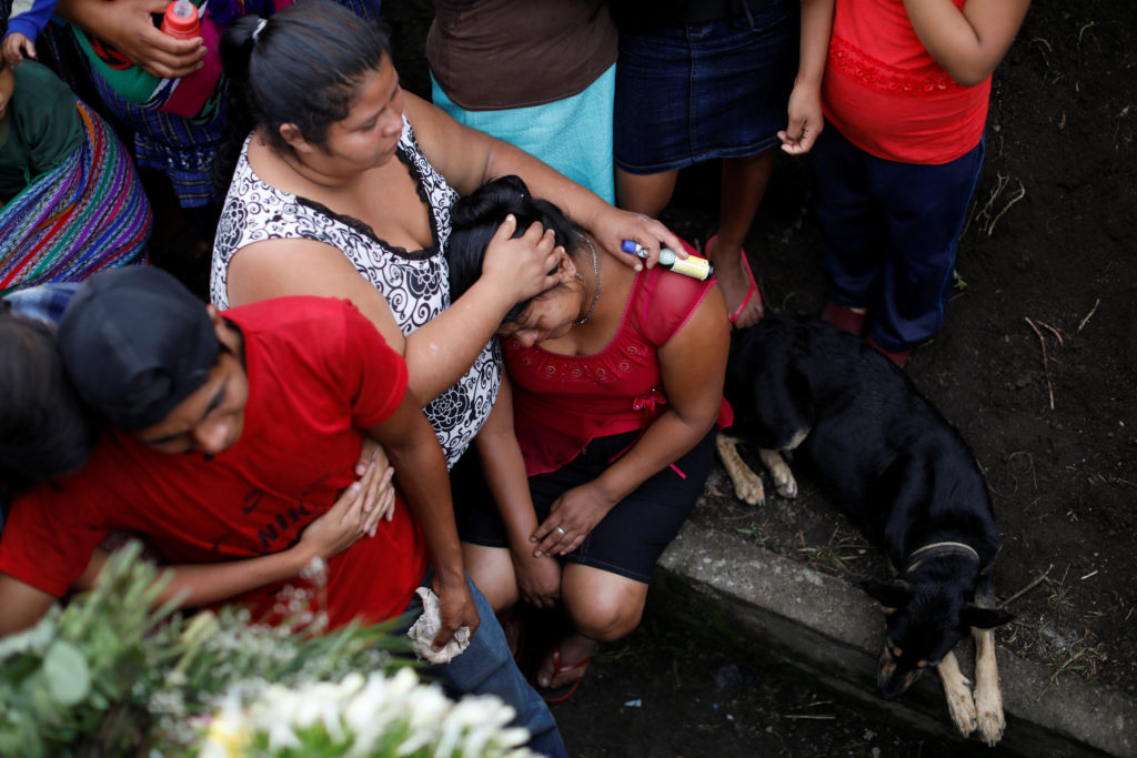 Relatives of Eric Rivas, 20, who died during the eruption of the Fuego volcano, mourn during his funeral in Alotenango, Gu...