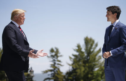 U.S. President Donald Trump approaches Canada's Prime Minister Justin Trudeau as he arrives at the G7 Summit in Charlevoix, Quebec, Canada, June 8, 2018. REUTERS/Leah Millis - HP1EE6819ZBXM