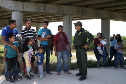 Border patrol agent Sergio Ramirez talks with immigrants who illegally crossed the border from Mexico into the U.S. in the Rio Grande Valley sector, near McAllen, Texas, in April. Photo by Loren Elliott/Reuters
