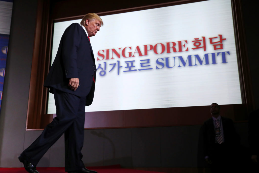 President Donald Trump walks off the stage after a news conference after his meeting with North Korean leader Kim Jong Un ...