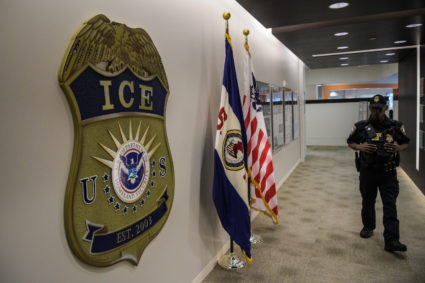 A law enforcement officer walks past ICE logo ahead of a press conference at the U.S. Immigration and Customs Enforcement headquarters in Washington, D.C. Photo by Salwan Georges/The Washington Post via Getty Images