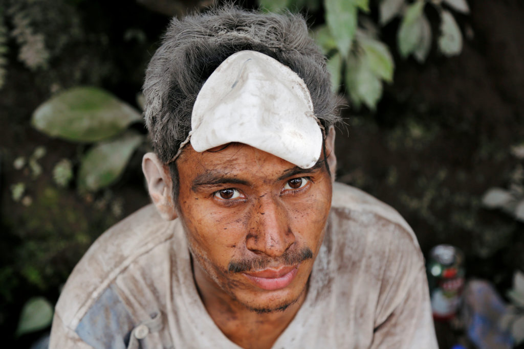 A man covered with ash after the eruption of the Fuego volcano, is seen at an area affected in the community of San Miguel...