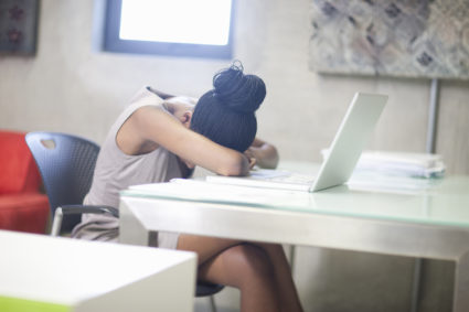 Office worker stressed and upset in office. Photo by Zero Creatives/via Getty Images