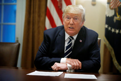 U.S. President Donald Trump reads from prepared remarks as he speaks about his summit meeting in Finland with Russian President Vladimir Putin at the start of a meeting with members of the U.S. Congress at the White House in Washington, July 17, 2018. REUTERS/Leah Millis