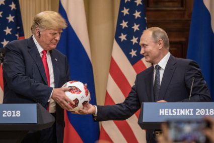 Russian President Vladimir Putin handed President Donald Trump a World Cup football during a joint press conference after their summit on July 16, 2018 in Helsinki, Finland. Photo by Chris McGrath/Getty Images)