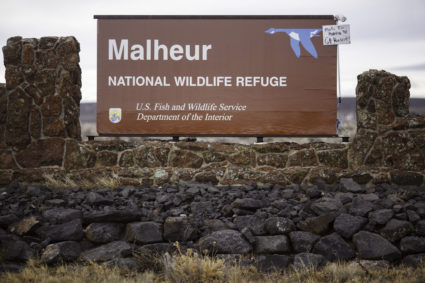 A mop and sign are taped to a sign for the occupied Malheur National Wildlife Refuge near Burns, Oregon on Jan. 29, 2016. Photo by Rob Kerr/AFP/Getty Images