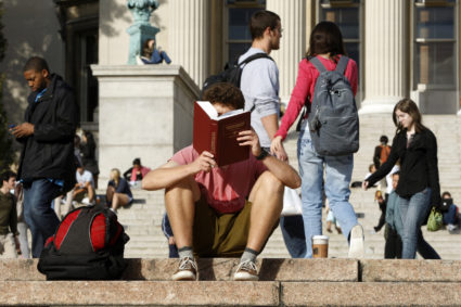 A student reads on the campus of Columbia University in New York. Photo by Mike Segar/Reuters