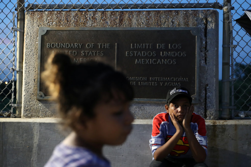 Honduran children seeking asylum wait on the Mexican side of the Brownsville & Matamoros International Bridge after their ...