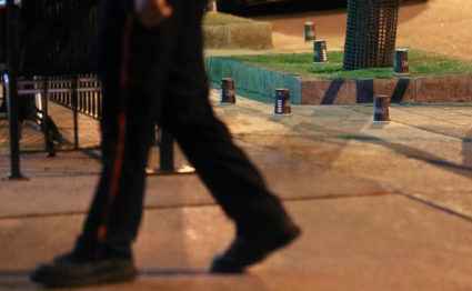 A police officer walks past evidence marked with coffee cups after a mass shooting in Toronto, Canada. Photo by Chris Helgren/Reuters