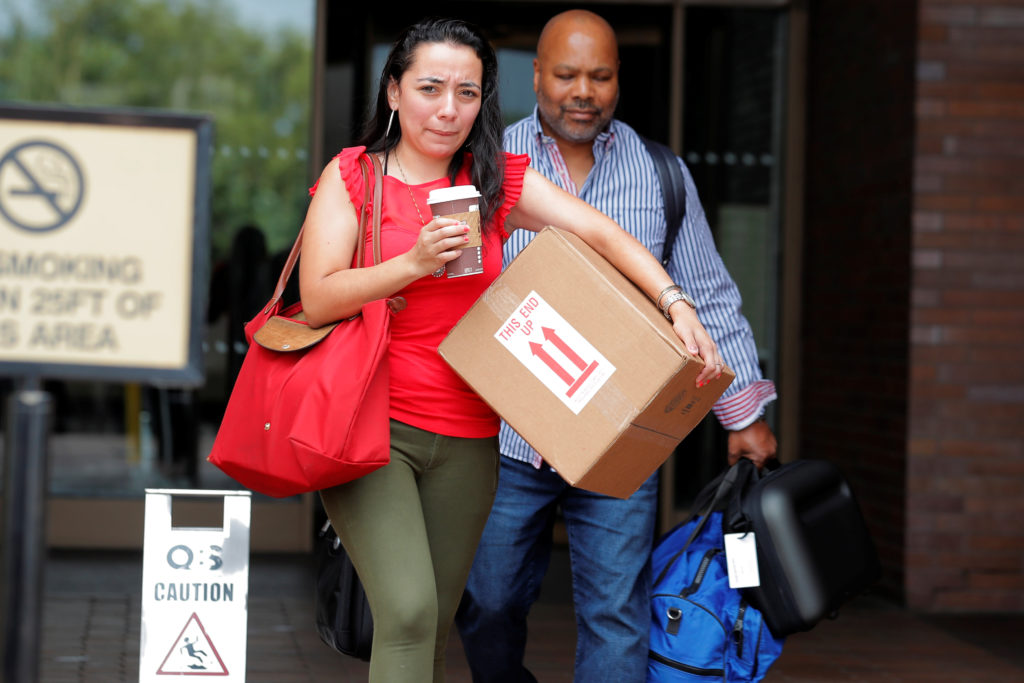 Former New York Daily News editorial staff members Carla Roman (L) and Reggie Lewis depart the newspaper's Manhattan office after reports that the paper was reducing its editorial staff by some 50 percent in New York. Photo by Brendan McDermid/Reuters
