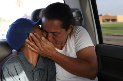 Maria Marroquin Perdomo and her 11-year-old son Abisai drive away from the Casa Padre facility in the backseat of her attorney's truck minutes after mother and son were reunified in Brownsville, Texas, on July 14, 2018. Abisai was held at Casa Padre while his mother was detained at the Port Isabel detention facility. Photo by Loren Elliott/Reuters