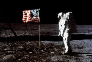 Astronaut Edwin E. Aldrin Jr., lunar module pilot, poses beside the deployed flag of the United States during the Apollo XI moon landing July 20, 1969. The lunar module is at left and the footprints of the astronauts are visible in the foreground. Photo by Reuters