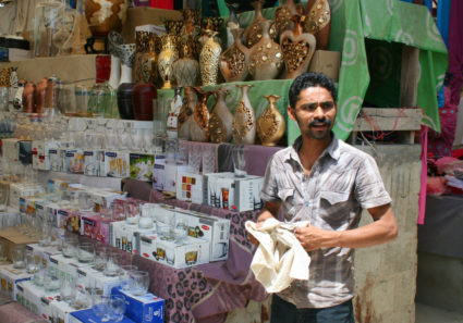 A man polishes his wares at a market in Karachi. Photo by Larisa Epatko/PBS NewsHour